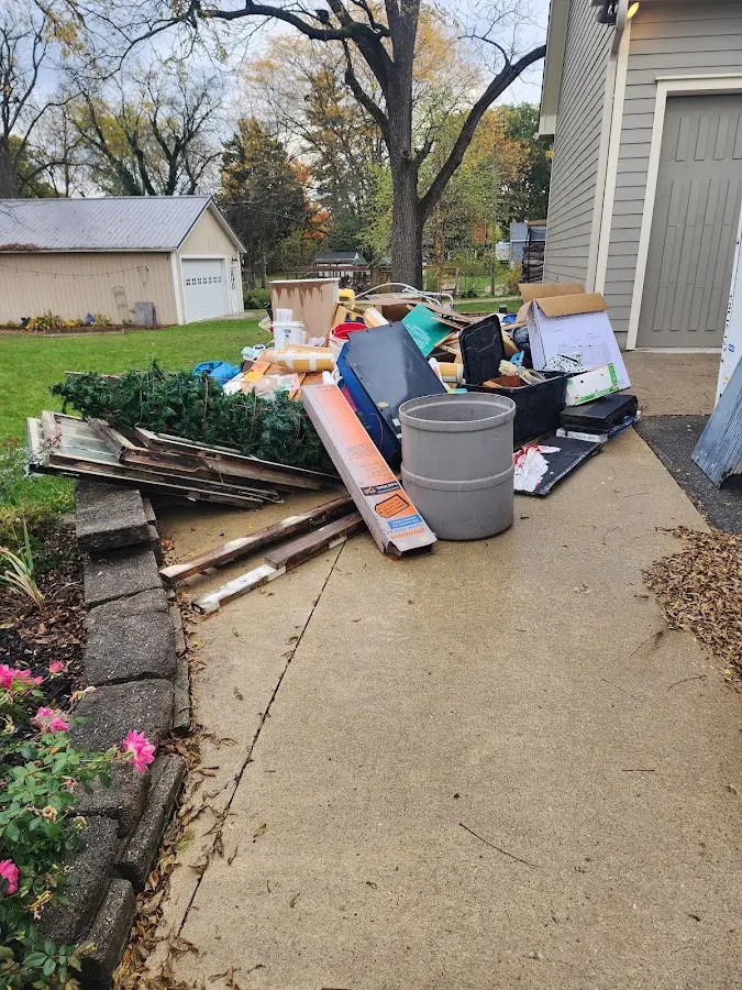 Dumpster being loaded with debris for Demolition Dumpster Rental in Negaunee